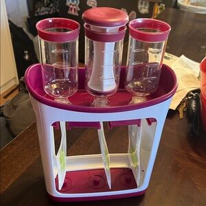 Purple and white squeeze station, baby food pouch filler